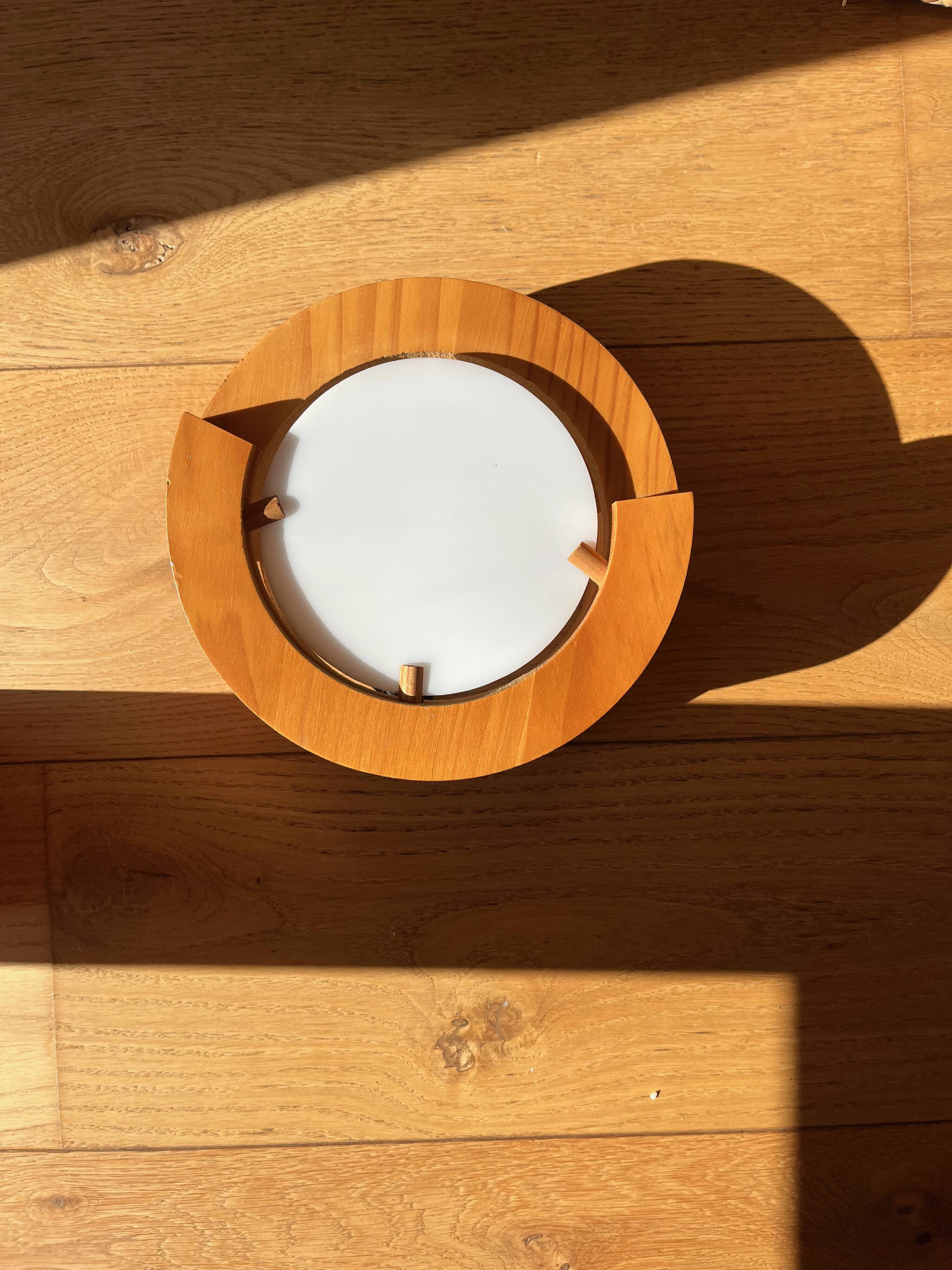 Round pine and plexiglass wall light, 1970s