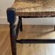 Corner chair made of turned wood with a straw seat.