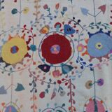 White suzani kilim rug with hand embroidered multi-colored patterns