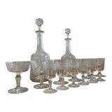 Engraved crystal service including 12 glasses and 2 carafes