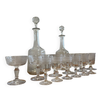 Engraved crystal service including 12 glasses and 2 carafes