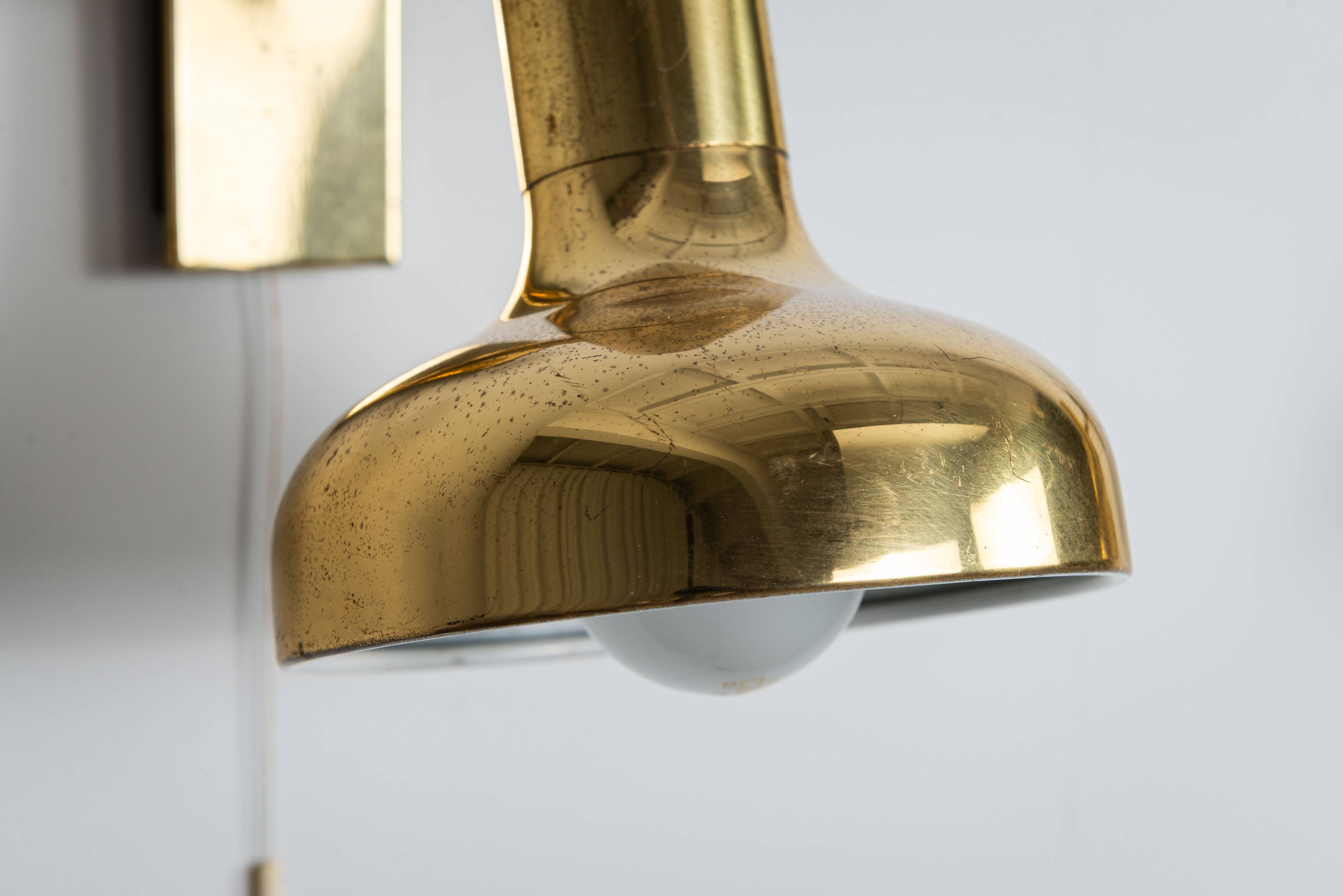 Set of three brass adjustable wall lamps