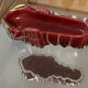 Pocket tray Michel Caugant, ruby-red ceramic and gilding - Vintage