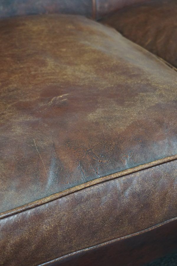 2-seater sofa in sheepskin decorative nails