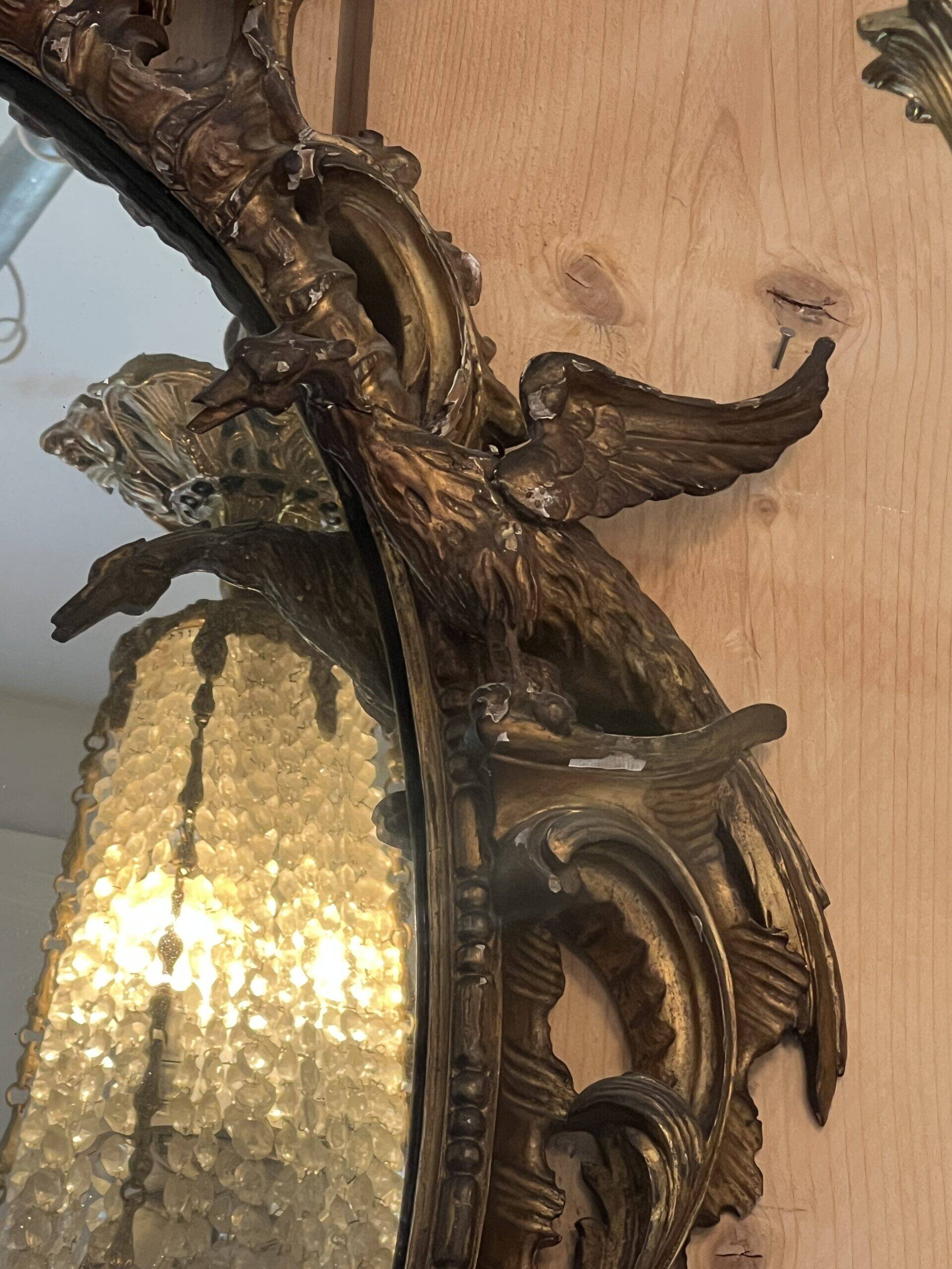 Large gilded wooden mirror, richly carved with winged dragons, 19th century