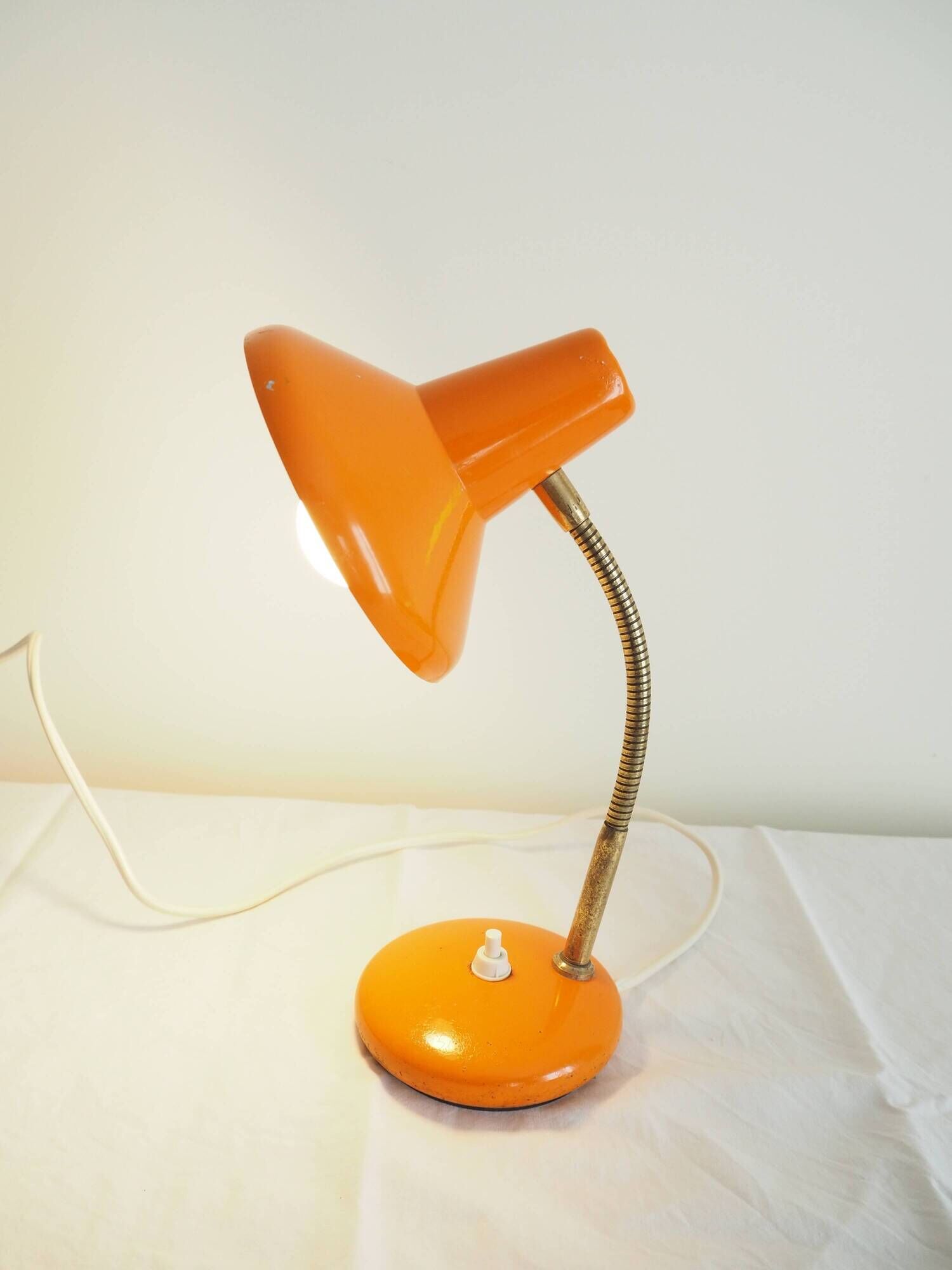 Orange colored metal desk lamp from the 1960s-1970s