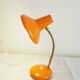 Orange colored metal desk lamp from the 1960s-1970s