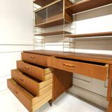 A piece of furniture combining a desk, wardrobe, and shelves.