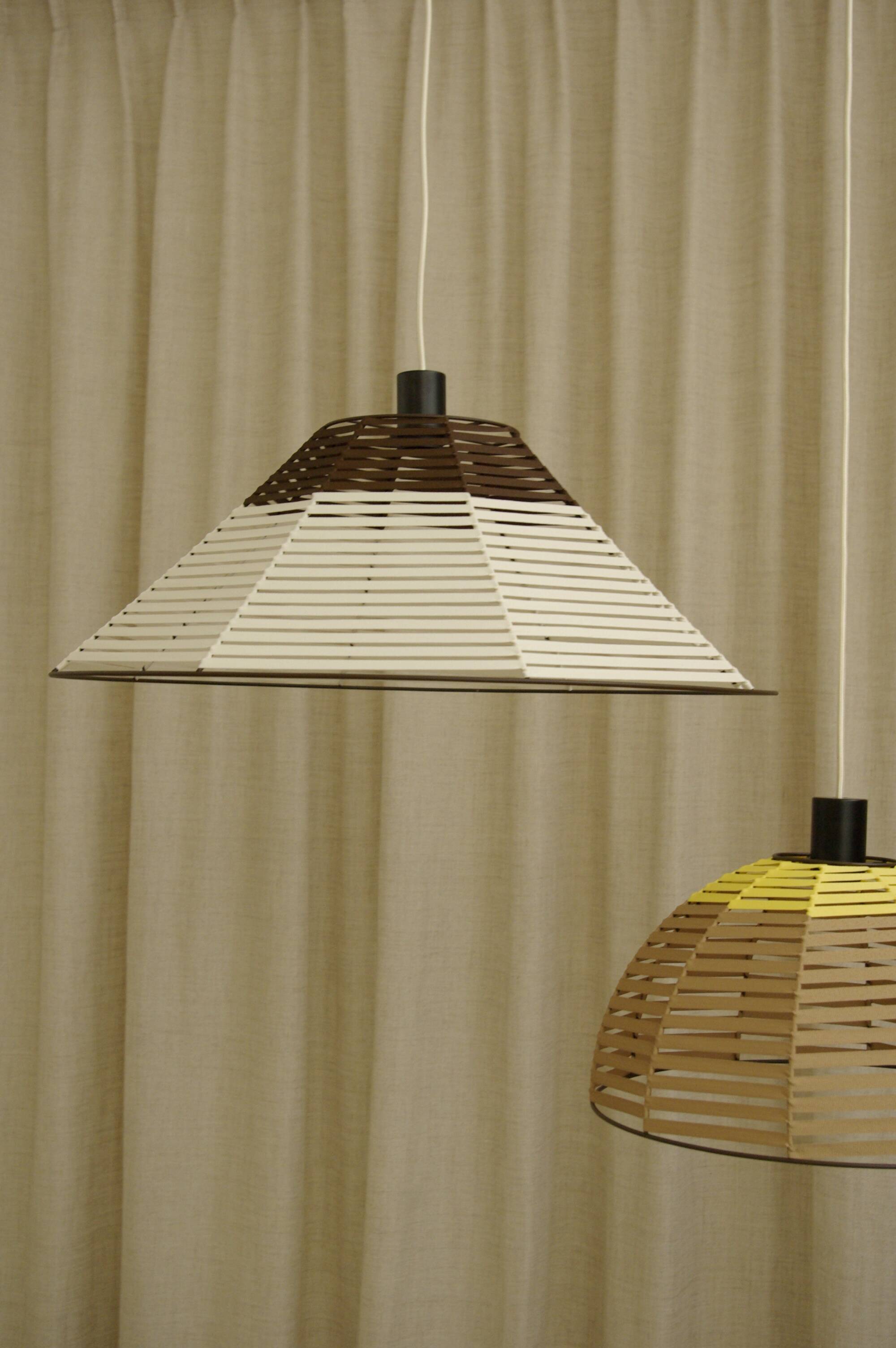 Woven bell suspension on metal structure.