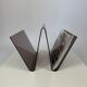Smoked plexiglass magazine rack in the shape of a W — 1970s