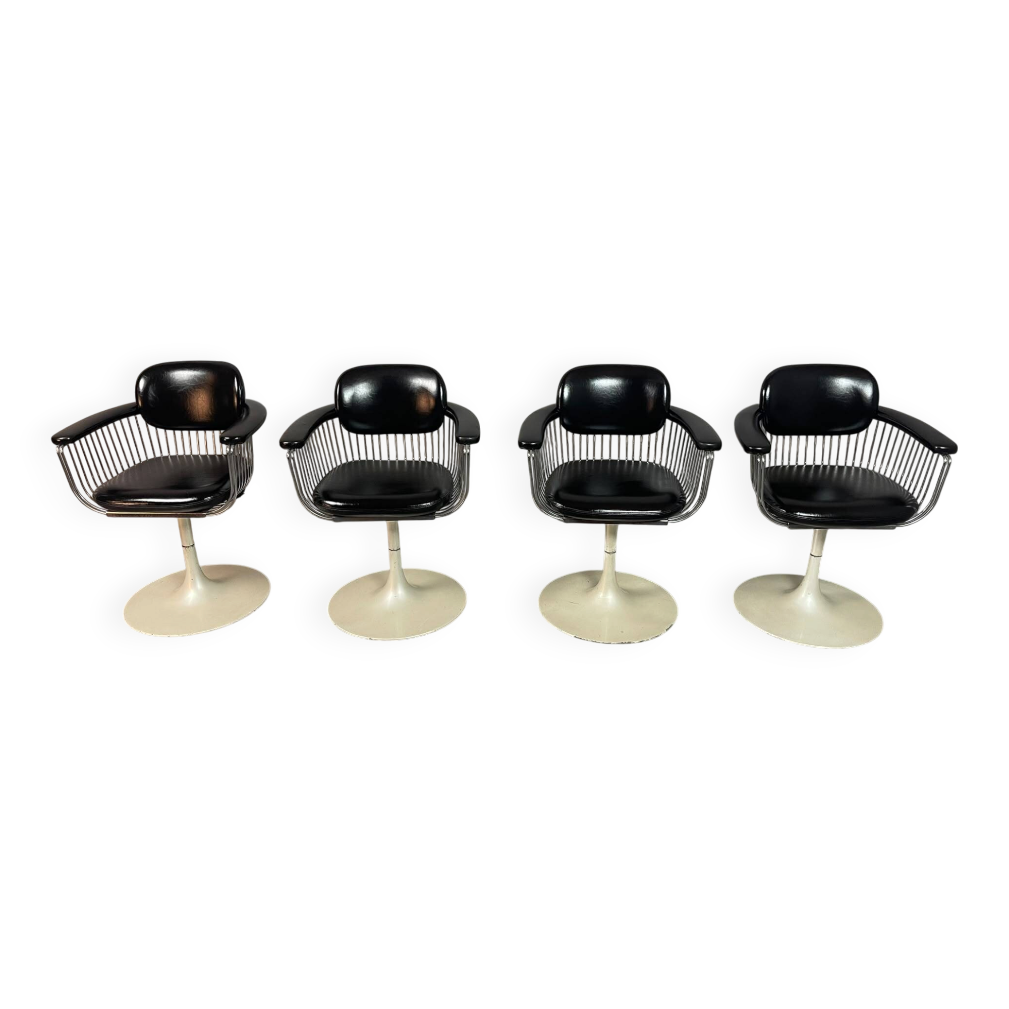 A striking set of four vintage swivel dining chairs
