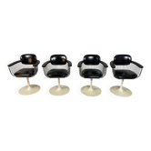 A striking set of four vintage swivel dining chairs