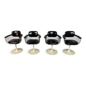 A striking set of four vintage swivel dining chairs