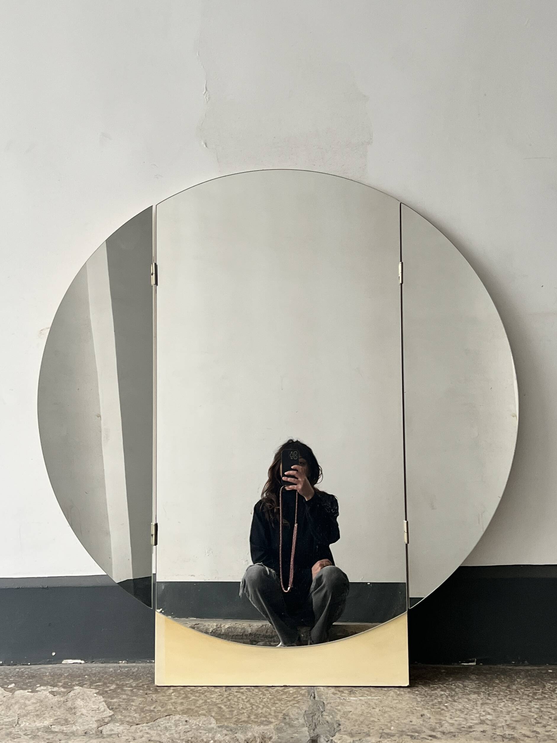 Large round triptych mirror with ivory background and back, 1970s design.