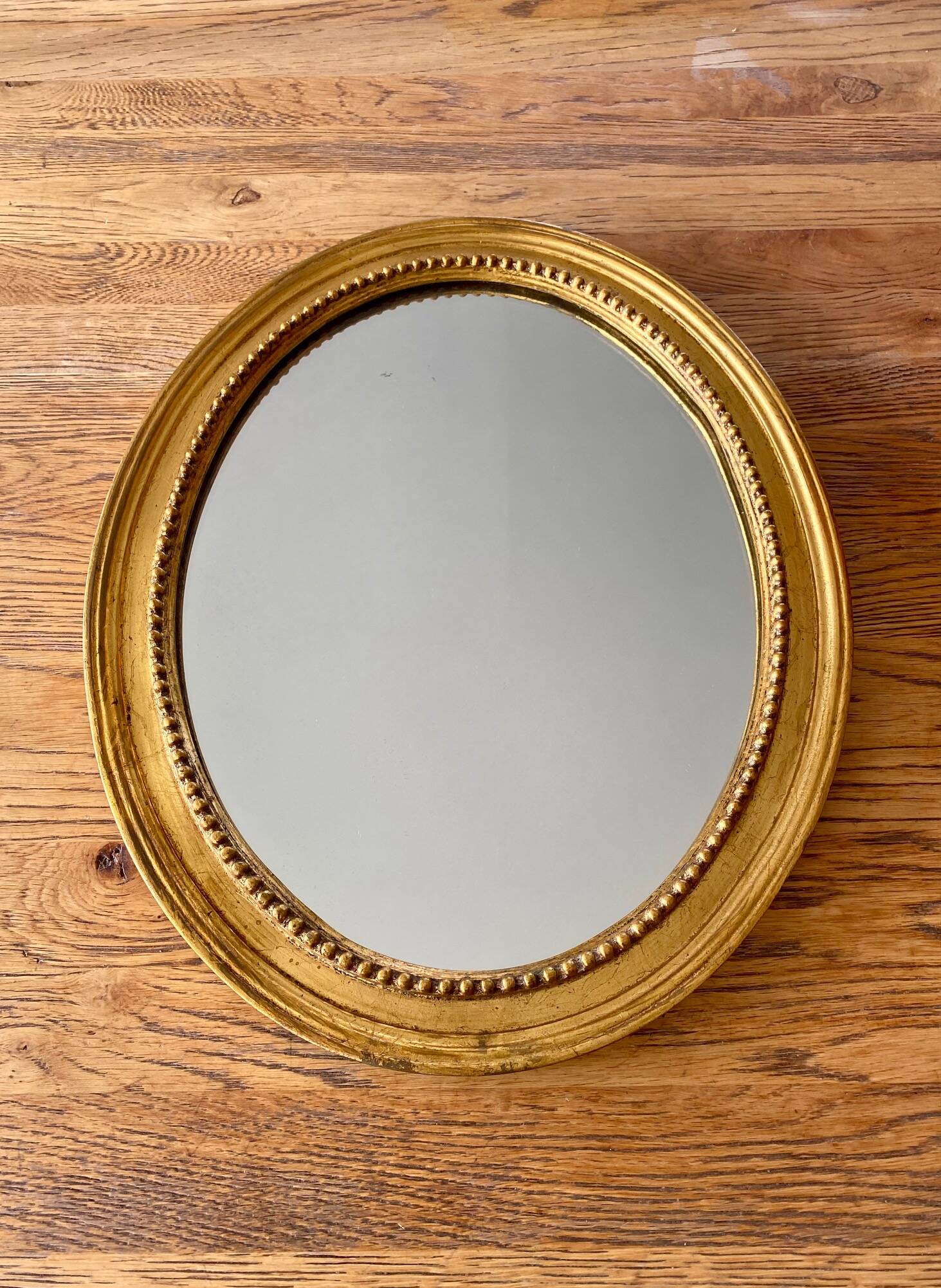 Antique gold oval mirror
