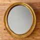 Antique gold oval mirror