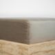 Cubic travertine stool with velvet cushion