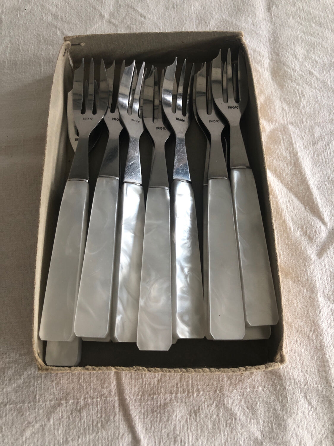 12 fourchettes à dessert manche plastique nacré blanc