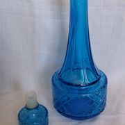 Turquoise glass carafe bottle with a stopper.