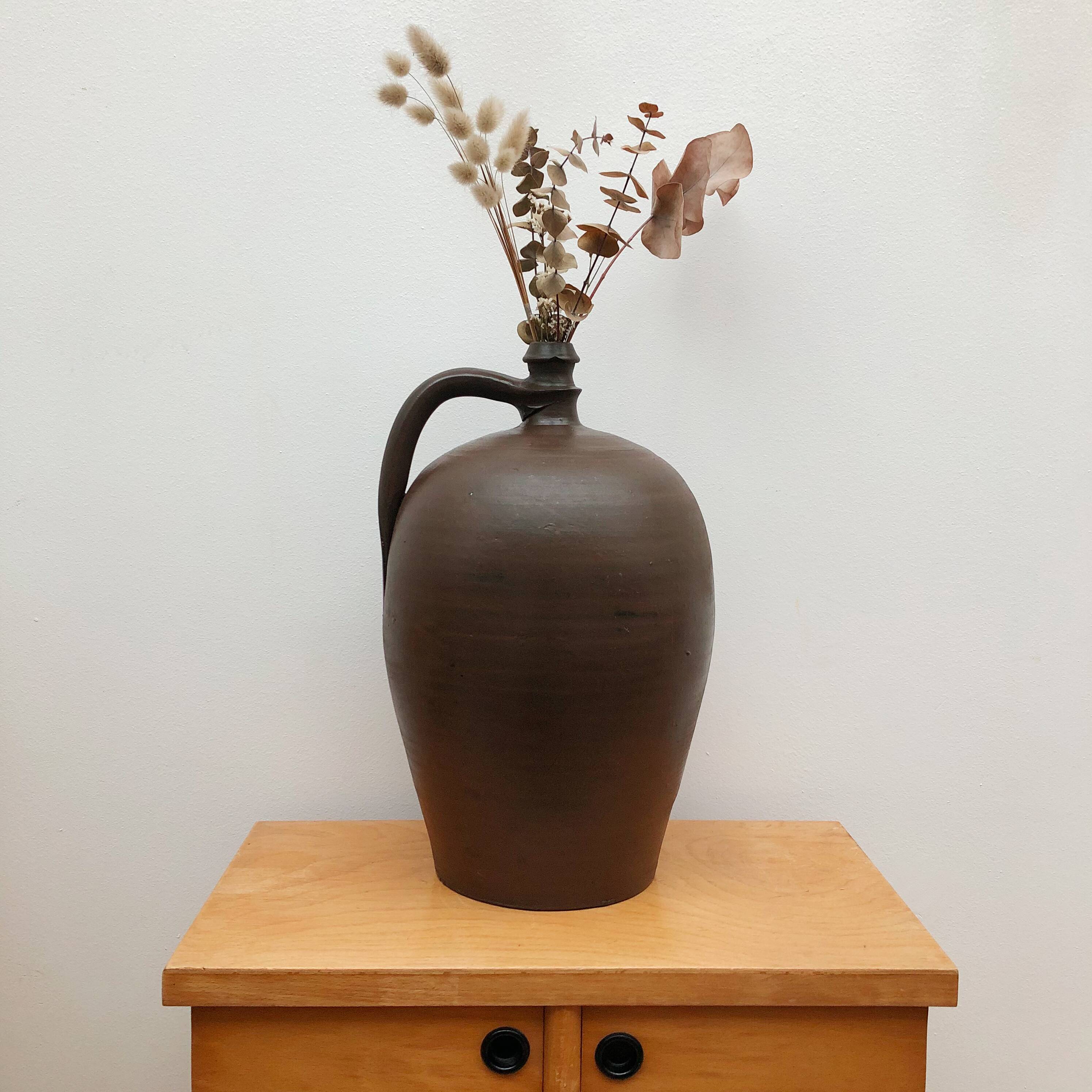 Ancient varnished sandstone jug