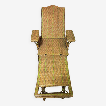 Old long chair rattan wicker garden armchair