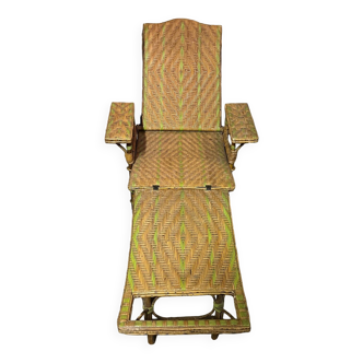 Old long chair rattan wicker garden armchair