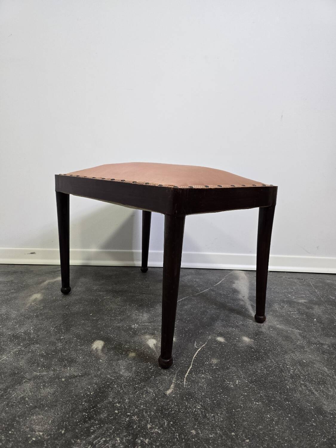 Vintage wooden ottoman from the 1940s with a silk top and studded trim.