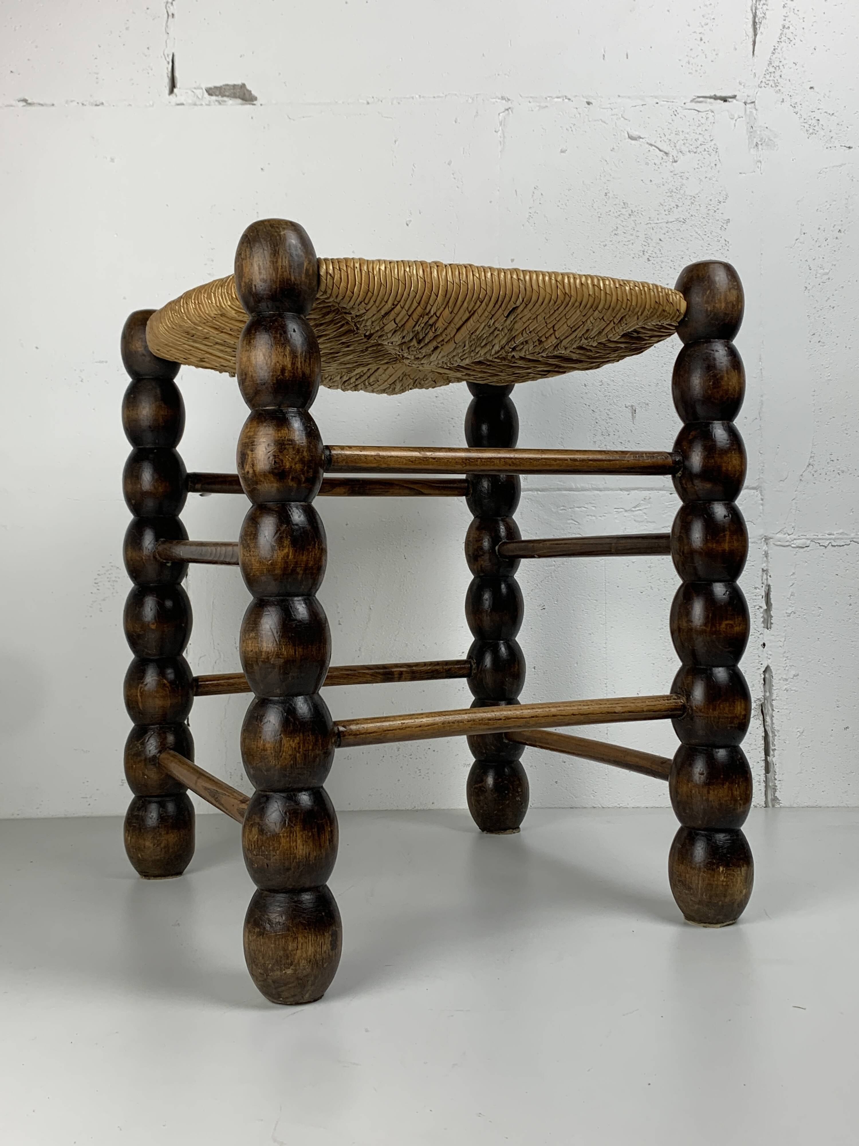 Brutalist wood turned bobbin rush stool in the style of Charles Dudouyt