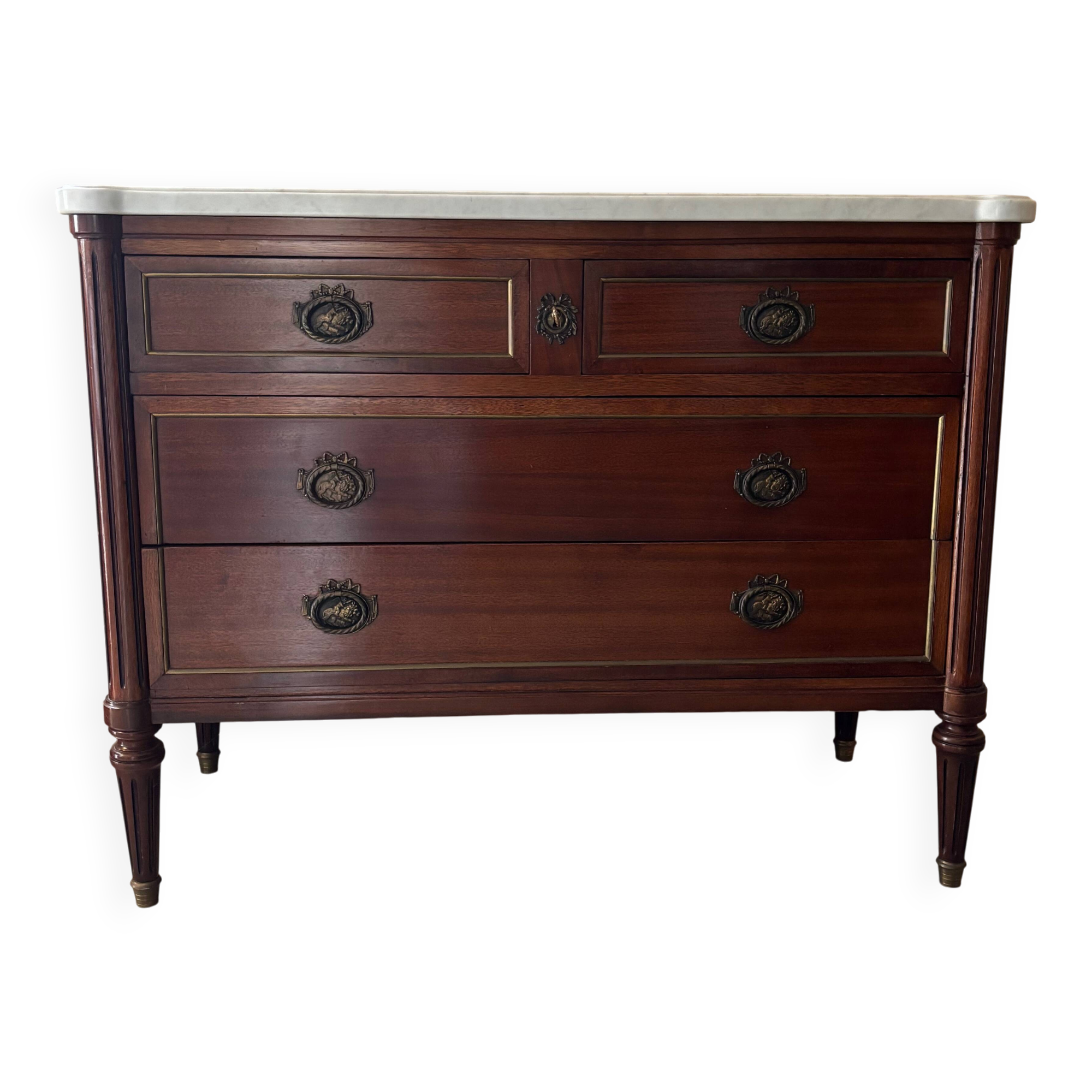 Louis XVI style commode with a shaped marble top.