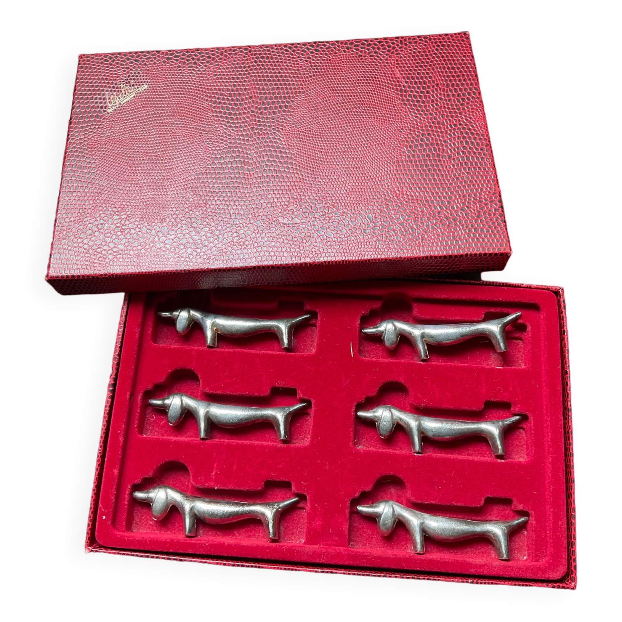 Series of vintage Dachshund knife holders in silver metal