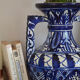 White hand-painted ceramic vase with blue patterns
