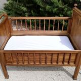 Old children's bed with retractable walnut bars