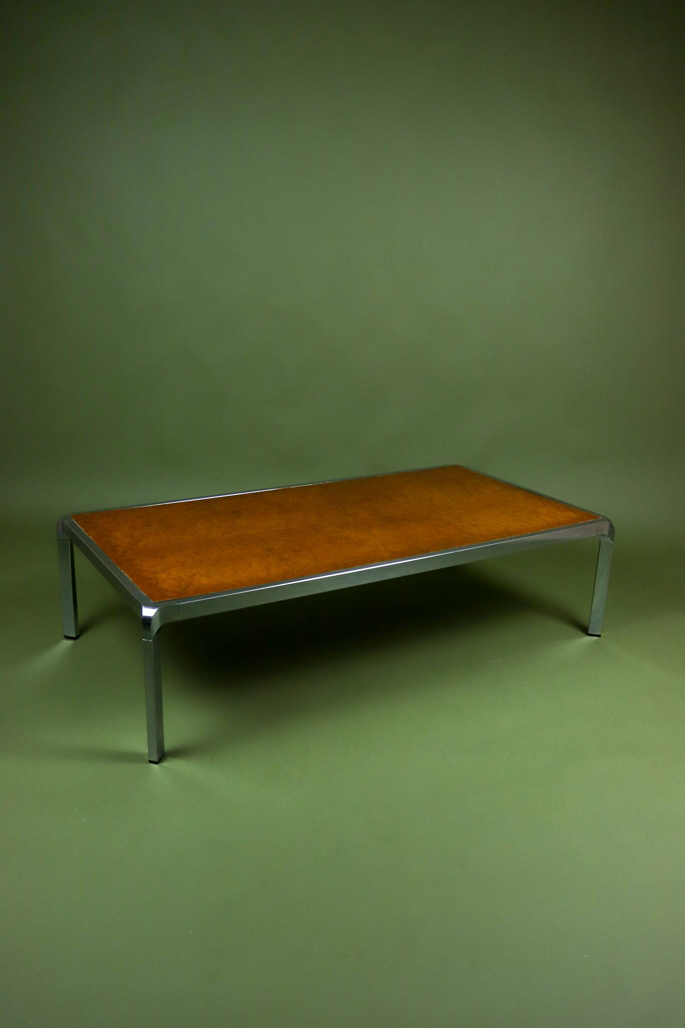 Vintage 1970s coffee table in chrome and burl wood.