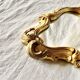 Rococo wall mirror in golden resin