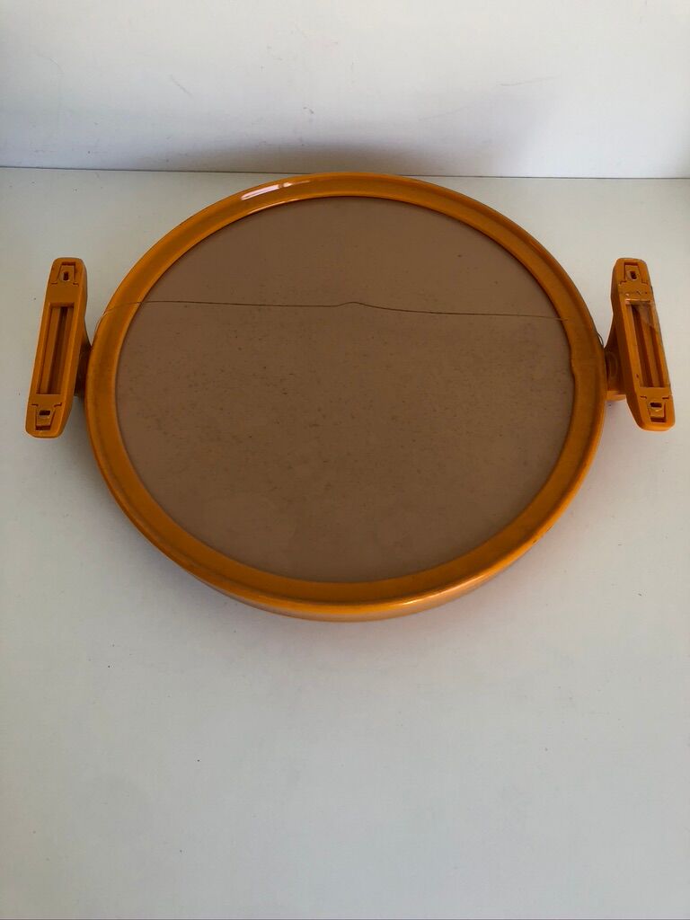 Tiltable orange plastic mirror with matching wall light