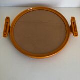 Tilting orange plastic mirror with its matching wall light