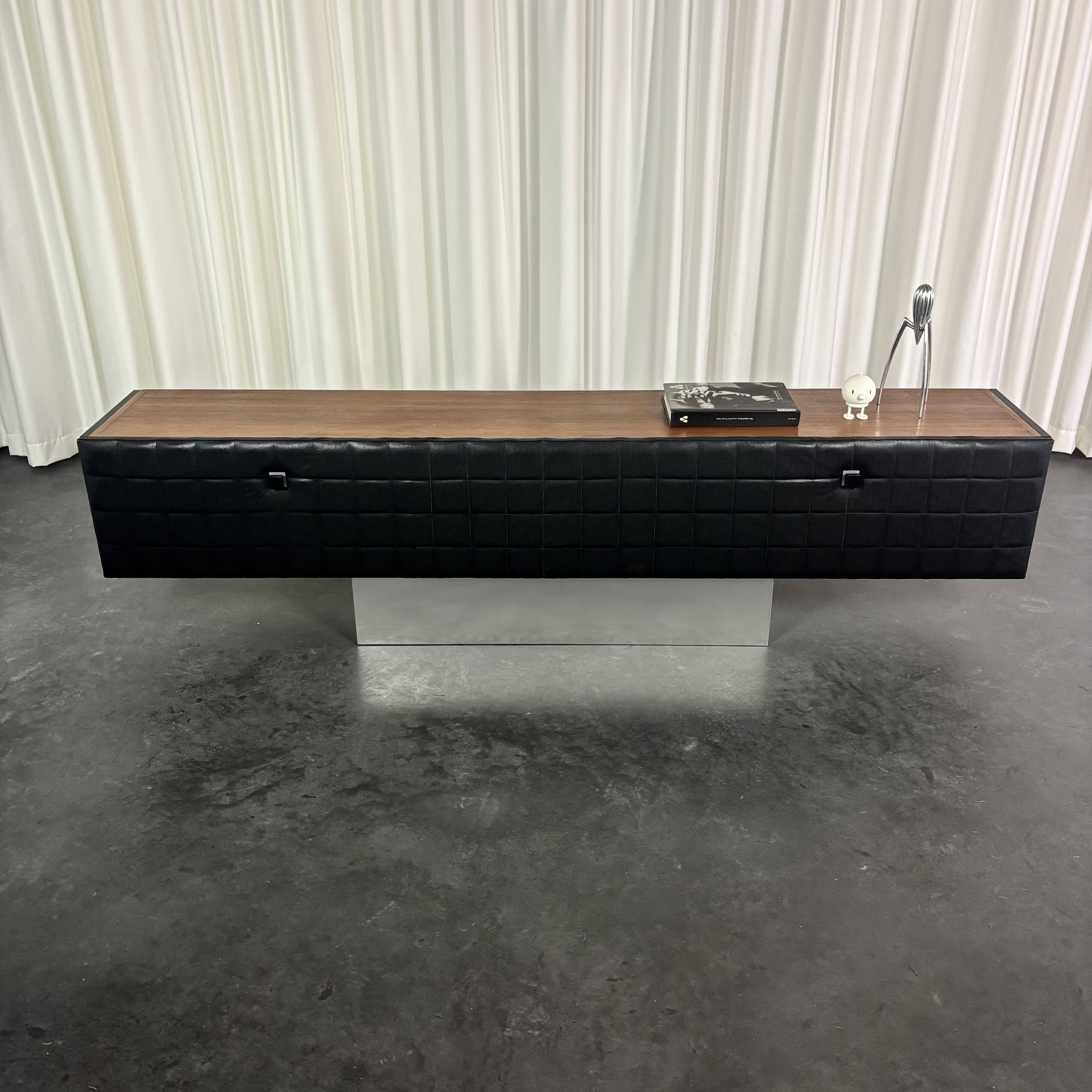 Modernist lowboard, faux leather, wood and stainless steel, 1960.