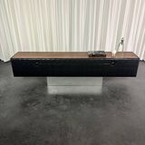 Modernist lowboard, faux leather, wood and stainless steel, 1960.