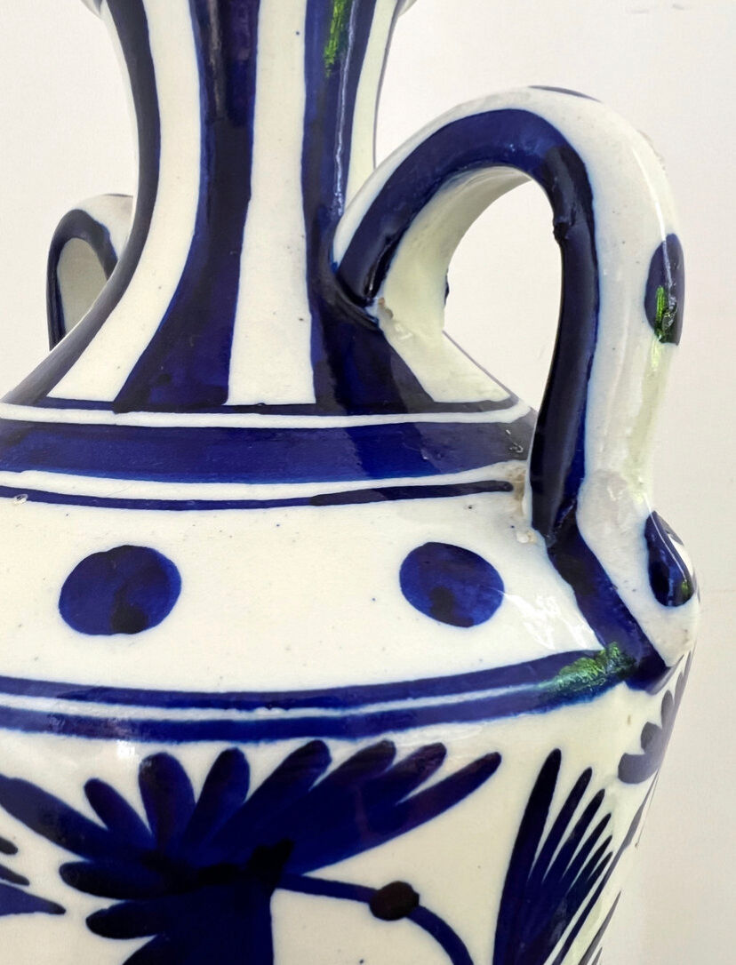 white amphora-style vase with hand-painted blue patterns