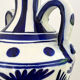 white amphora-style vase with hand-painted blue patterns