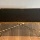 Neoclassical brass coffee table with a black leather top and golden borders from Maison Jansen.