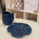 Set of ceramic artisan mugs with a pop of petrol blue water lily design.