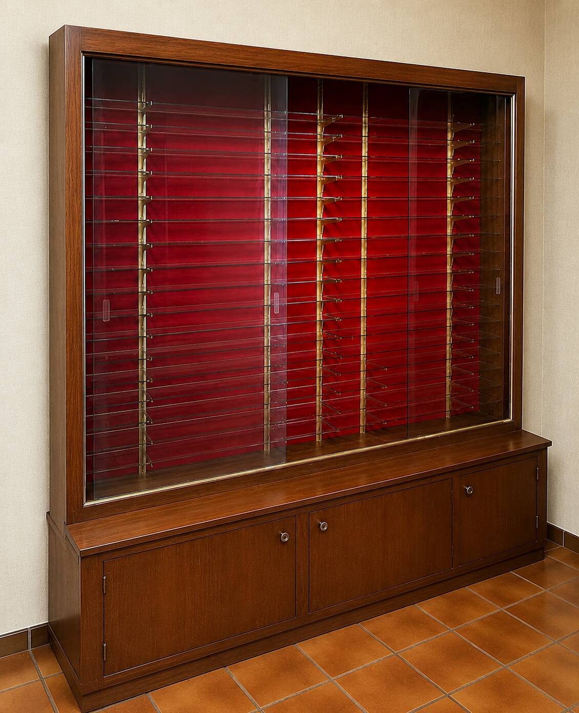 Large vintage display cabinet in wood and glass – red background, 15 shelves