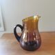Vintage round pitcher amber glass