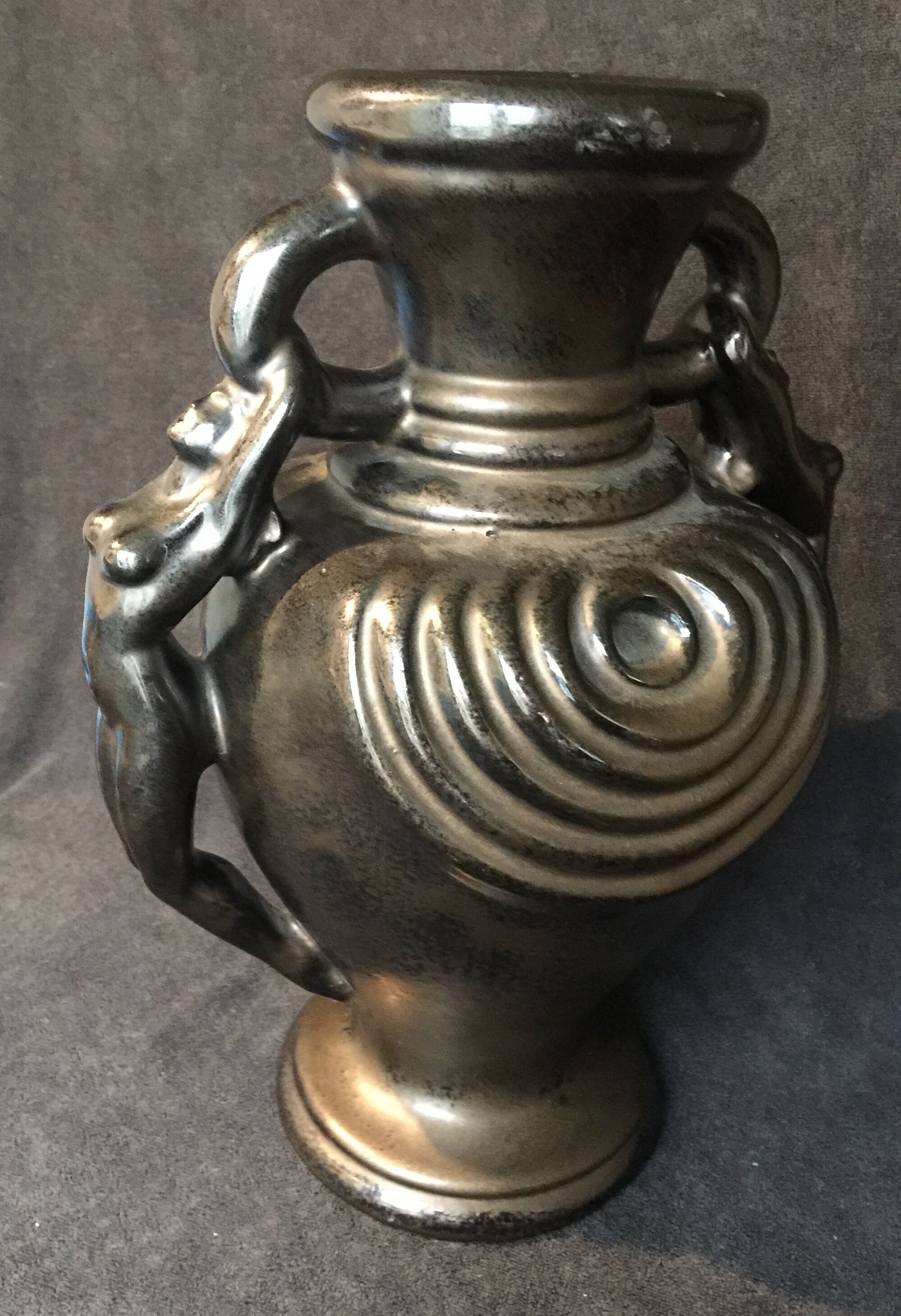 Black ceramic vase caught in naked women's bodies