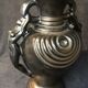 Black ceramic vase caught in naked women's bodies