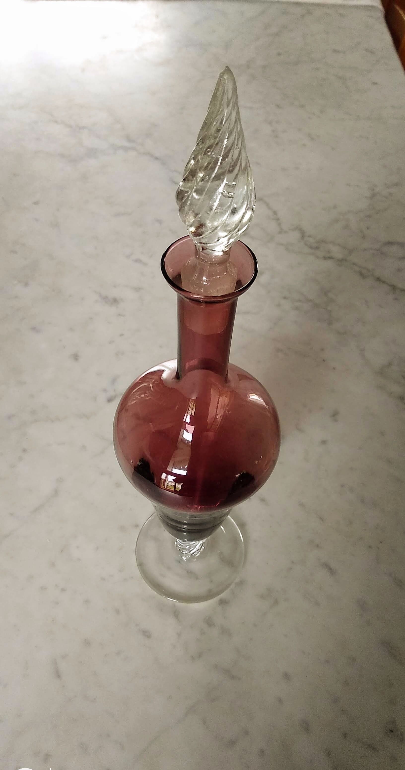 Purple-colored liquor-blown glass decanter with carved foot