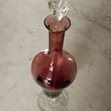Purple-colored liquor-blown glass decanter with carved foot