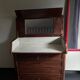 Vintage wooden toilet commode with marble top.