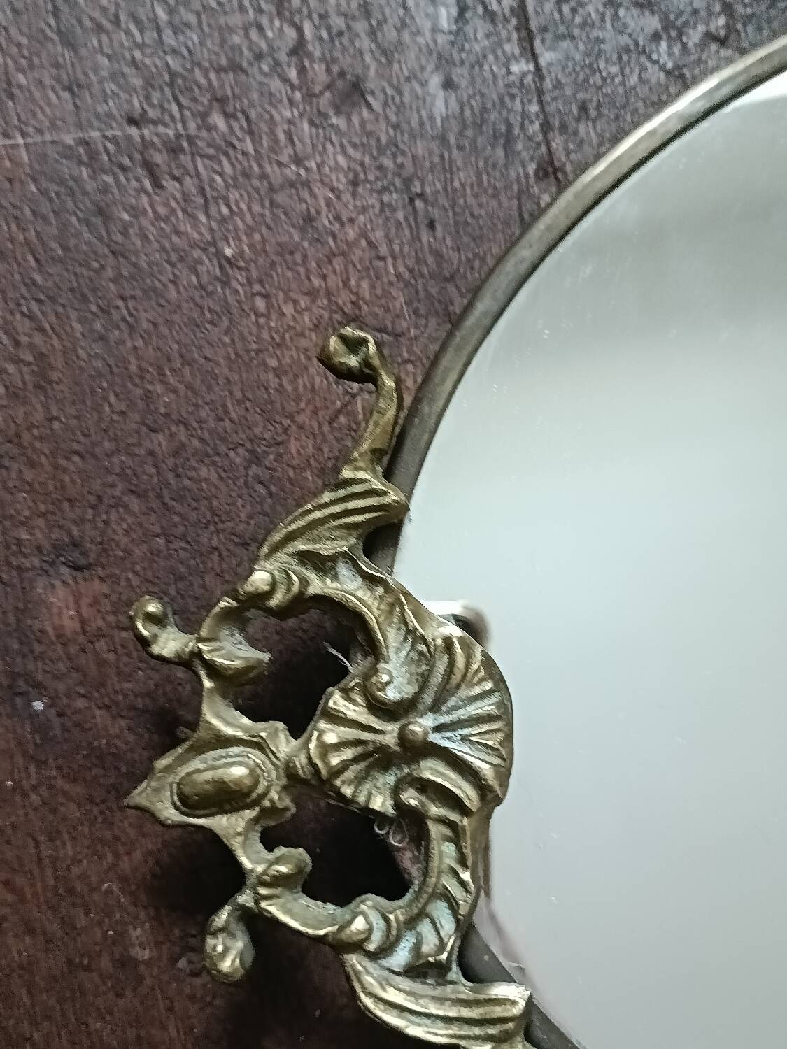Antique mirror, oval with brass crest